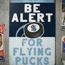 Seattle kraken be alert for pucks metal sign