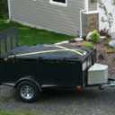 The X-Cover by TRPx - Trailer and Truck Bed Cover Large - Integrated Heavy Duty Black Tarp and Tie Down System. Fits: Standard Bed, Long Bed Trucks and Utility Trailers up to 8' Long.