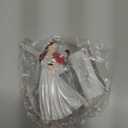 Clara Holding a Nutcracker Christmas Ornament