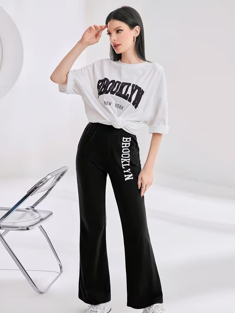 WDIRARA Girl's 2 Piece Outfits Letter Graphic Print Half Sleeve T Shirt and Flare Leg Pants Set, Black & White, 10Y