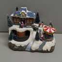 MOMENTS IN TIME Animated Musical Christmas Village 8.5H Light Up Holiday Scene with LED Lights Moving Train & Carousel Battery Operated Christmas Tabletop Decoration