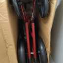 Medline Lightweight Foldable Transport Wheelchair with Handbrakes and 12-Inch Wheels, Red Frame, Black Upholstery