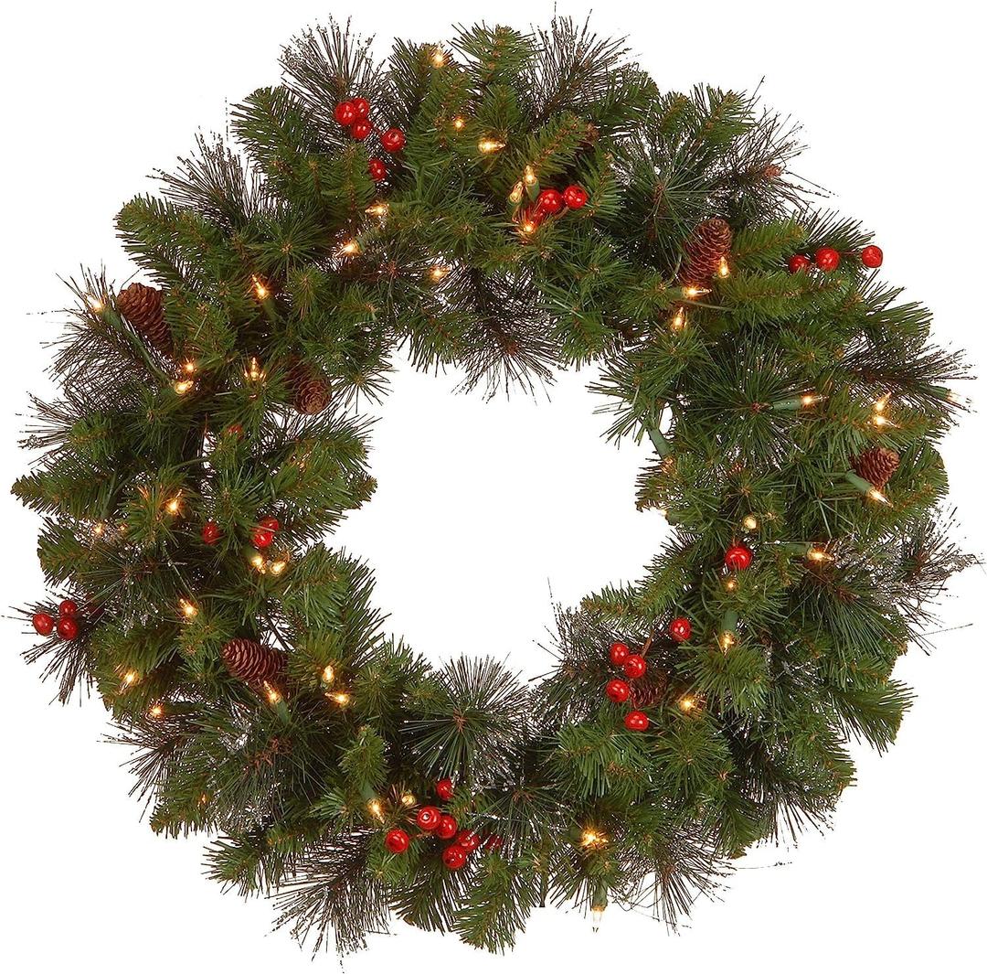 National Tree Company 24 in Pre-Lit Crestwood Spruce Artificial Christmas Wreath, Christmas Decoration with Glitter, Pinecones, Red Berries, 50 Clear Lights, 160 Tips, Green