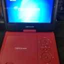 DBPOWER 11.5" Portable DVD Player, 5-Hour Built-in Rechargeable Battery, 9" Swivel Screen, Support CD/DVD/SD Card/USB, Remote Control, 1.8 Meter Car Charger, Power Adaptor and Car Headrest (Red)