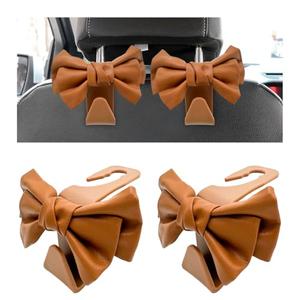NYTKL 2 PCS Car Seat Headrest Hooks, Cute Bow Shaped Vehicle Backseat Purse Holder Storage Hook, Bow Knot Seat Back Hooks Hanging Organizer for Coat Umbrellas Grocery Bag (Brown)