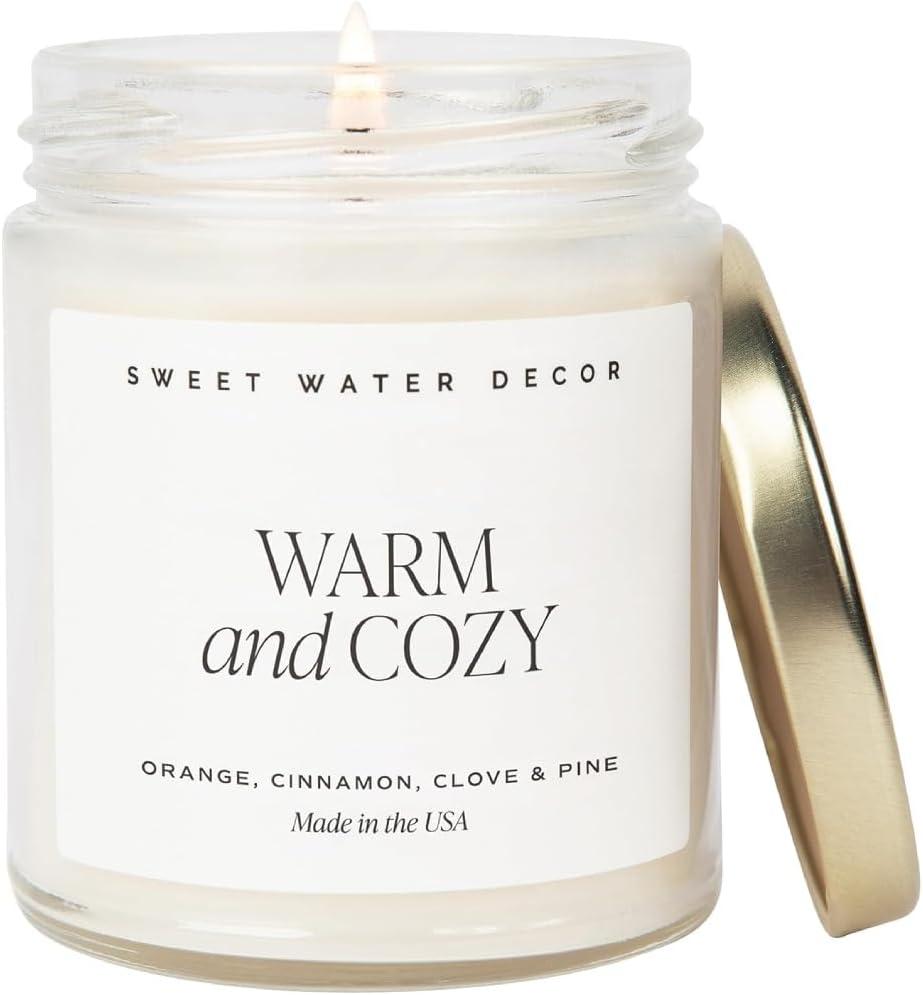Sweet Water Decor Warm and Cozy Candle - Orange Peel, Cinnamon, Ginger and Clove Soy Winter Scented Candles for Home - 9oz Clear Jar + Gold Lid, 40+ Hour Burn Time, Made in The USA (Text Label)
