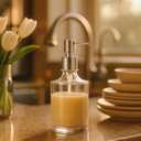 OGGI 10oz Round Glass Soap Dispenser with Satin Silver Pump  Elegant Refillable Oggi Soap Dispenser for Bathroom, Kitchen Sink, or Hand Sanitizer  Rust-Resistant Dispenser Pump for Daily Use (Clear)