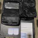 Travel Compression Packing Cube Set by the Brand Bagail. The carry bag is black and there are 8 total various packing bags of different sizes from a zip pouch to a cube the size of 18"x14"x5".