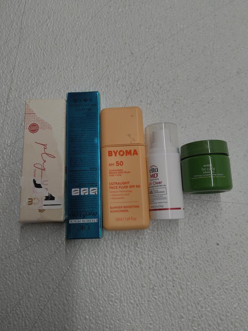 Hair-like Strokes Eyebrow Pen; EltaMD UV Clear Face Sunscreen SPF 46;  JUICE Play Up Lip Crayon-Play; BYOMA SPF 50 Face Fluid; Aveda Be Curly Advanced Intensive Curl Perfecting Masque