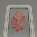 framed piece of decorative home art featuring a watercolor painting of an autumn oak leaf. 30x22 inch