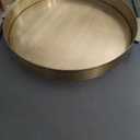 Kate and Laurel Samana Modern Glam Round Metal Tray; 17 Inch Diameter; Antique Brass; Circular Polished Decorative Tray with Hammered Surface and Minimalist Handles