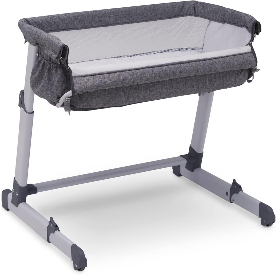 Delta Children Simmons Kids Dream Bedside Bassinet with Zip-Down Side Wall – Convenient Baby Sleeper with Breathable Mesh and Adjustable Heights - Lightweight Portable Crib, Grey