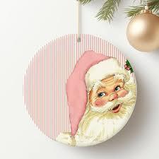 HUGANE Vintage Funny Christmas Pink Santa Round Wall Art Decor, Pink and White Stripe Xmas Santa Claus Hanging Canvas Framed Prints Wall Sculptures for Home Bedroom Living Room Decor, 10x10 Inch