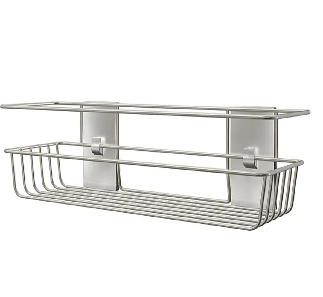Wall-mounted organizer designed to hold shower essentials like shampoo, body wash, and soap.