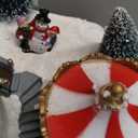 MOMENTS IN TIME Animated Musical Christmas Village 8.5H Light Up Holiday Scene with LED Lights Moving Train & Carousel Battery Operated Christmas Tabletop Decoration