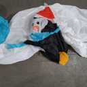 nflatable arch with snowman soldiers on both ends and a polar bear, blue snowflake, and cute Santa penguin in the middle of the archway