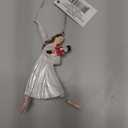 Clara Holding a Nutcracker Christmas Ornament