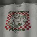 Teenage Mutant Ninja Turtles Men's Distressed Michelangelo's Pizzeria T-Shirt, S