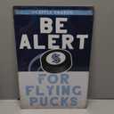 Be Alert For Flying Pucks Metal Sign