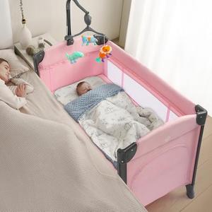 JOYMOR Baby Bedside Bassinet, Baby Bassinet, Pack n Play Convert Playpen, Quick Foldable Travel Bed, Wheels & Brake, Carry Bag for Boys Girls (Pink)