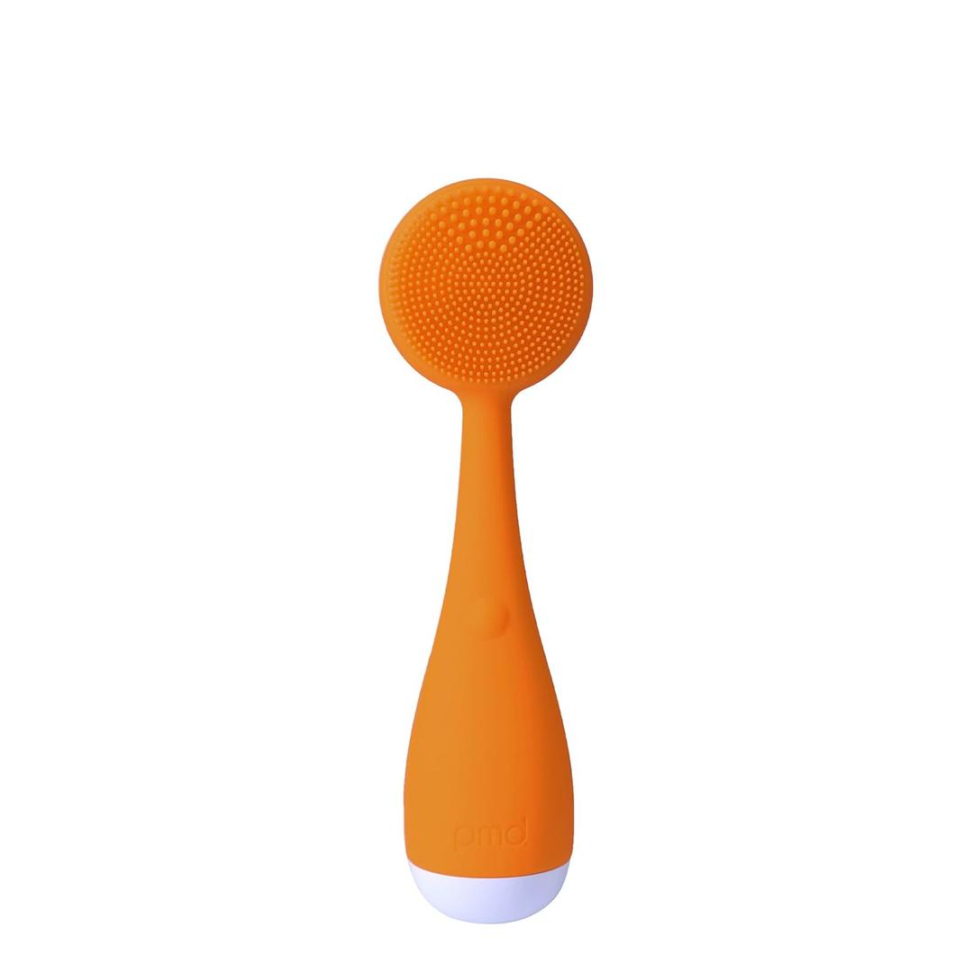 PMD Clean Mini - Smart Facial Cleansing Device with Silicone Brush & Anti-Aging Massager - Waterproof - SonicGlow Vibration Technology - Clear Pores and Blackheads - Lift, Firm, and Tone Skin (Orange)