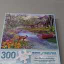 Bits and Pieces 300 Piece Jigsaw Puzzle for Adults Spring Cabin - Forrest River Boat Pier Flower Tree Nature Bloom Jigsaw Puzzle by Artist Bigelow Illustrations, Completed Puzzle Size: 18" x 24"