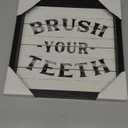 designed for bathroom decor, featuring a reminder to "BRUSH YOUR TEETH" in black text on a white shiplap-style background. 12"×12"