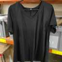 Black T shirt is 2XL and the Brown Sports Bra is Size M