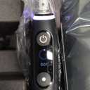 Oral-B iO Deep Clean + Protect Rechargeable Electric Toothbrush, Black with a iO Series 7 Toothbrush, 2 Replacement Brush Heads, and a Charging Travel Case