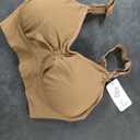 Black T shirt is 2XL and the Brown Sports Bra is Size M