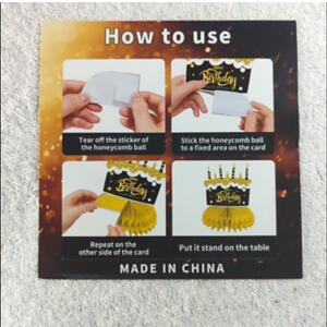 The image displays a package for honeycomb table centerpieces, specifically a "Graduation Centerpiece 10 Pcs (Orange)". The package also includes instructions on how to assemble these decorations, which are commonly used for parties and events. 
How