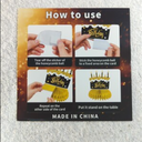 The image displays a package for honeycomb table centerpieces, specifically a "Graduation Centerpiece 10 Pcs (Orange)". The package also includes instructions on how to assemble these decorations, which are commonly used for parties and events. 
How