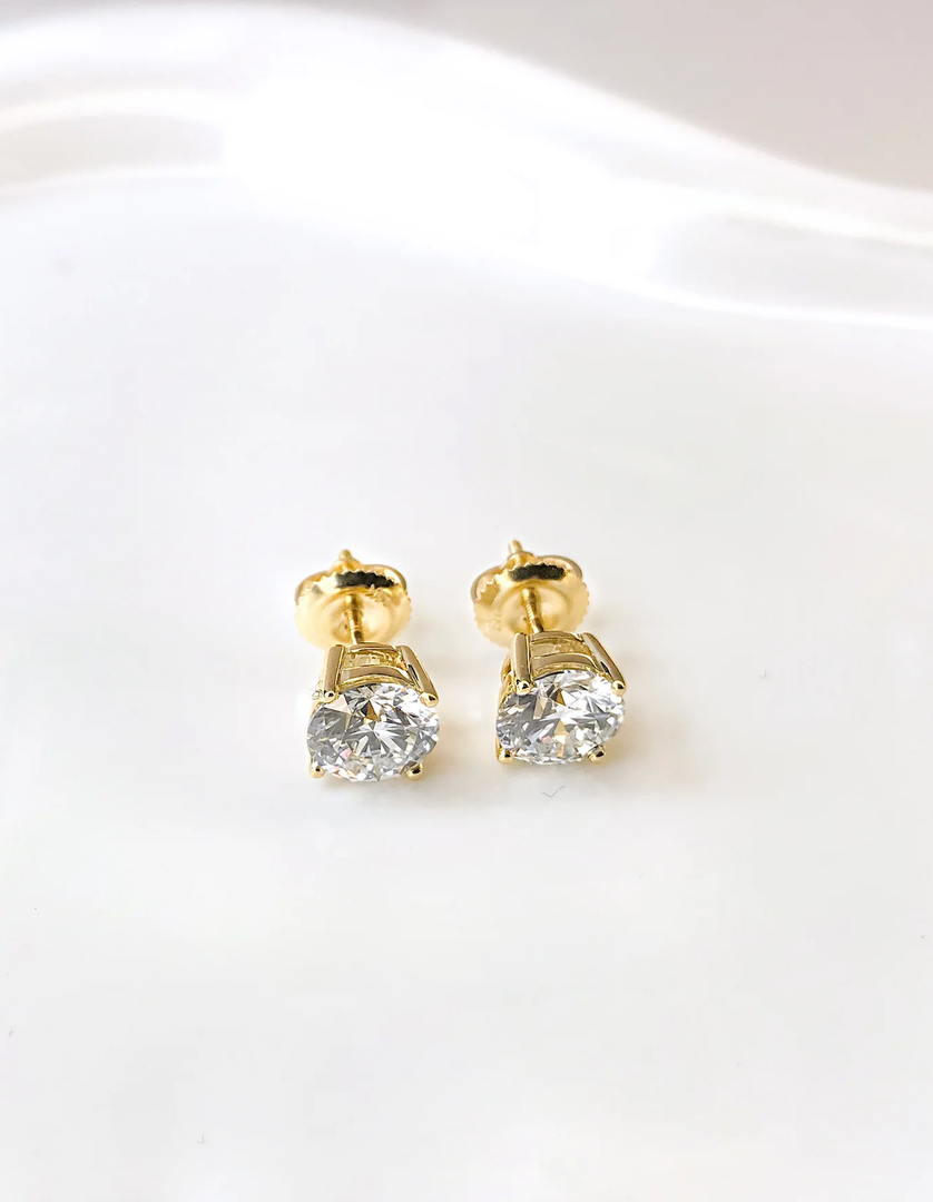 Pair of laboratory-grown diamond stud earrings with two round brilliant cut stones, total carat weight approximately 1.00 ct, color G–H, clarity VS1–VS2. Includes laboratory jewelry report dated December 28, 2024