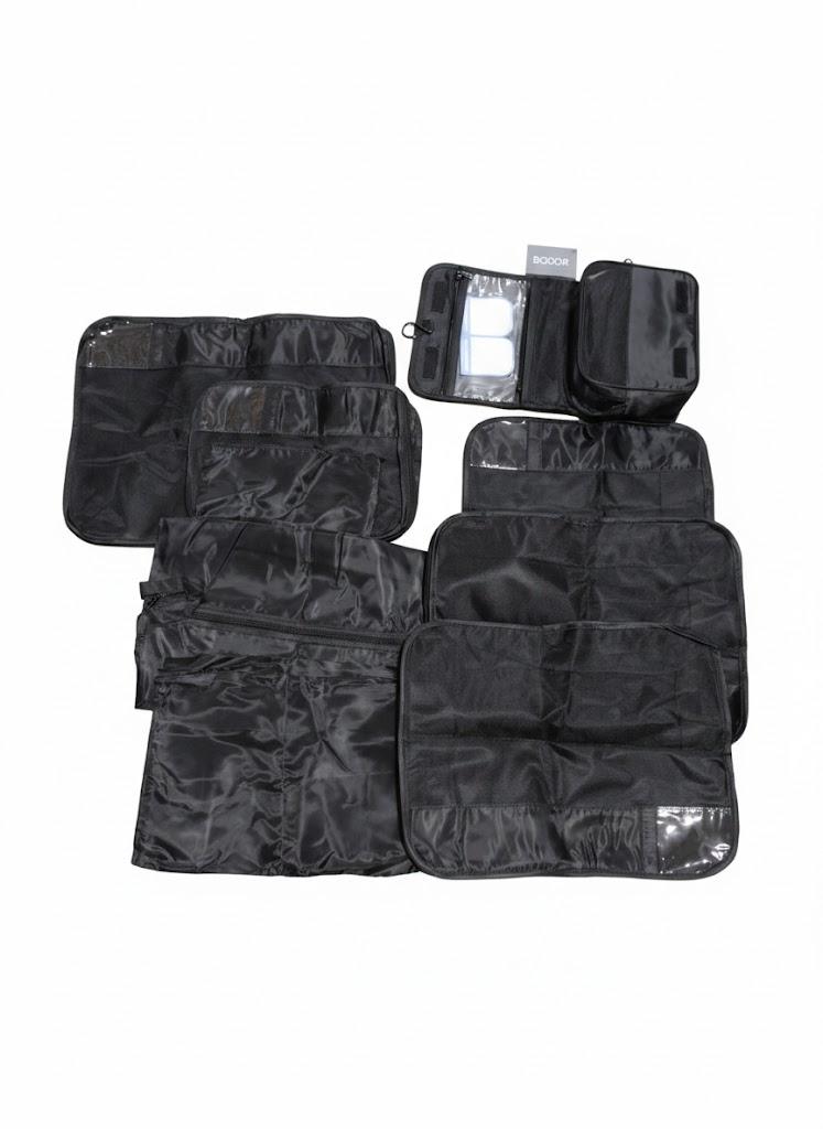 Travel Compression Packing Cube Set by the Brand Bagail. The carry bag is black and there are 8 total various packing bags of different sizes from a zip pouch to a cube the size of 18"x14"x5".