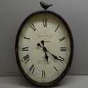 Creative Co-Op Oval Metal Wall Clock with Bird