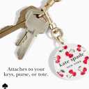 kate spade new york AirTag Holder with Gold Ring Clip - Cherry Dot | Stylish, Anti-Scratch, and Protective Case for Apple AirTag - Attaches Securely to Bags, Luggage, Keys, Purse, Totes & More
