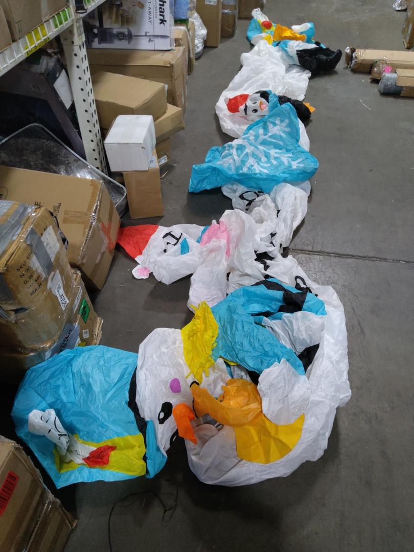 nflatable arch with snowman soldiers on both ends and a polar bear, blue snowflake, and cute Santa penguin in the middle of the archway