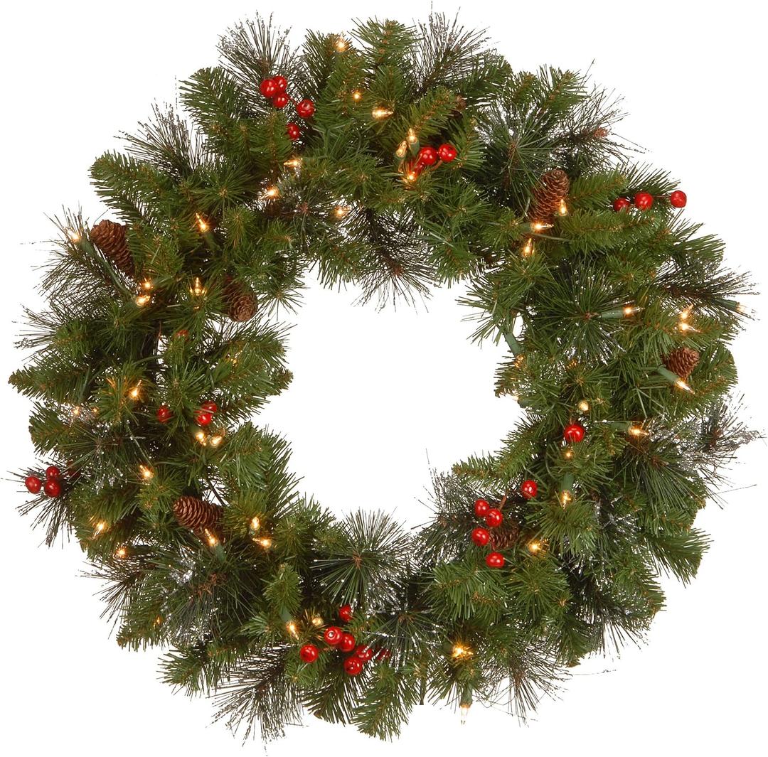 National Tree Company 24 in Pre-Lit Crestwood Spruce Artificial Christmas Wreath, Christmas Decoration with Glitter, Pinecones, Red Berries, 50 Clear Lights, 160 Tips, Green