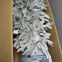 Puleo International 4.5ft Pre-Lit Potted Flocked Arctic Fir Christmas Tree with 70 Clear Lights, 419 Realistic Dense Snow Flocked Branch Tips, Easy Setup Artificial Trees with Sturdy Stand