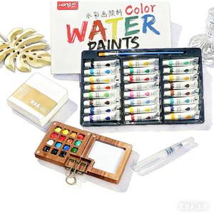 Mini Watercolor Paint Set, Mini Watercolor Travel Set with 1 Wooden 15-Grid Palette, 24 Colors Paint, 1 Sketch Books and 1 Brushes, Copper Clip and Sketchbook for Travel Painting